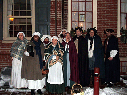 Huddled for warmth, the Colonial Revelers add a note of Christmas Cheer to Elfreth's Alley in Historic Philadelphia.