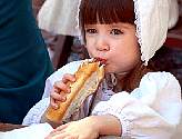 Singing with the Colonial Revelers makes this little girl hungry.